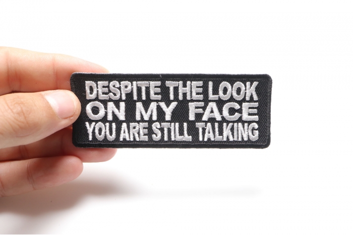 Despite The Look On My Face You're Still Talking Funny Iron on Patch shown on hand for size comparison
