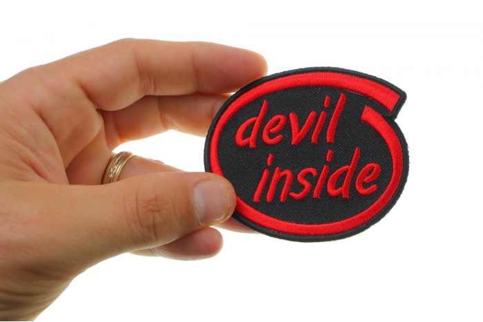 Devil Inside Funny Iron on Patch shown on hand for size comparison