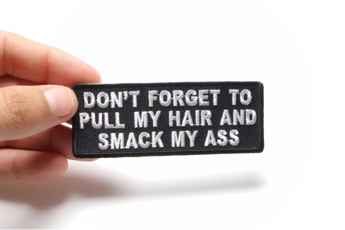 Don't Forget To Pull My Hair and Smack My Ass Funny Iron on Patch shown on hand for size comparison