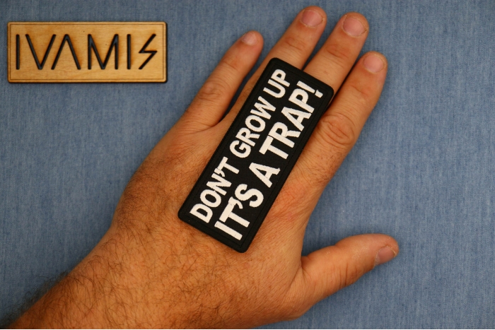 Don't Grow Up It's a Trap Patch, Funny Saying Patches, Sew or Iron on Patch shown on hand for size comparison