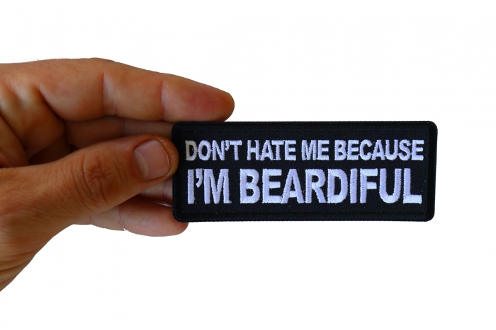 Don't Hate me Because I'm Beardiful Funny Iron on Patch shown on hand for size comparison