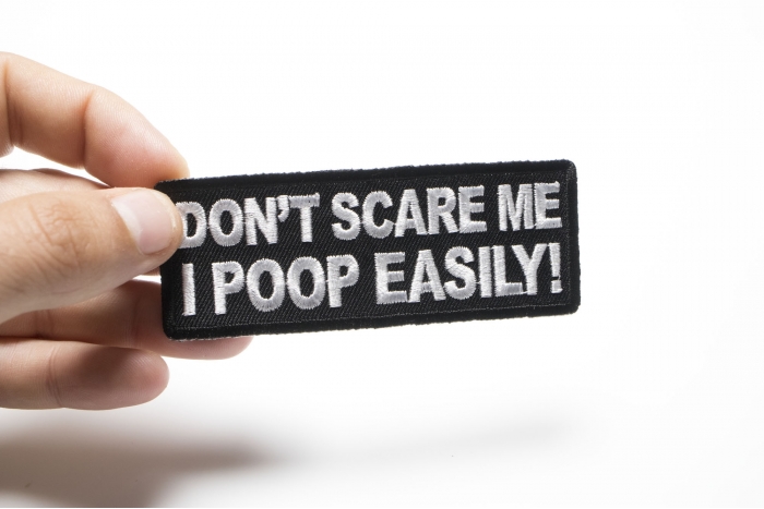 Don't Scare me I Poop Easily Funny Iron on Patch shown on hand for size comparison