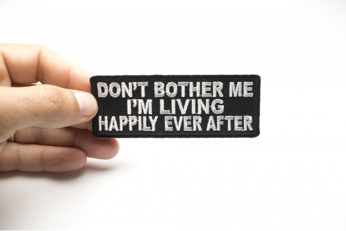 Don't Bother Me I'm Living Happily Ever After Funny Patch shown on hand for size comparison