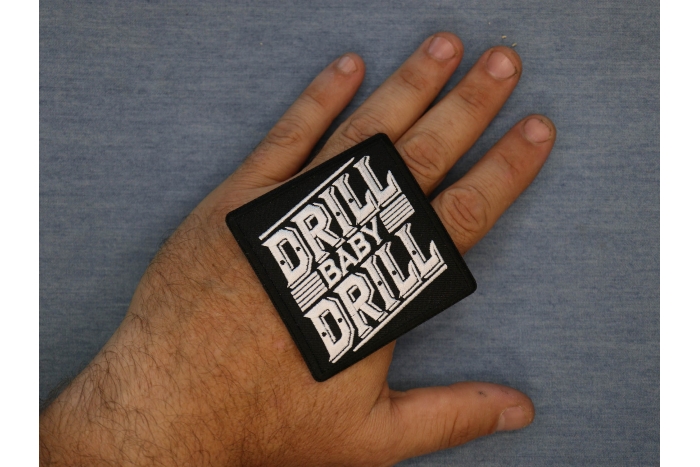 Drill Baby Drill Patch shown on hand for size comparison