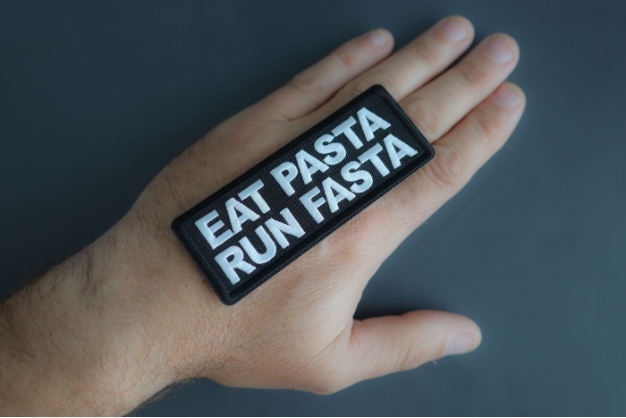Eat Pasta Run Fasta Patch shown on hand for size comparison