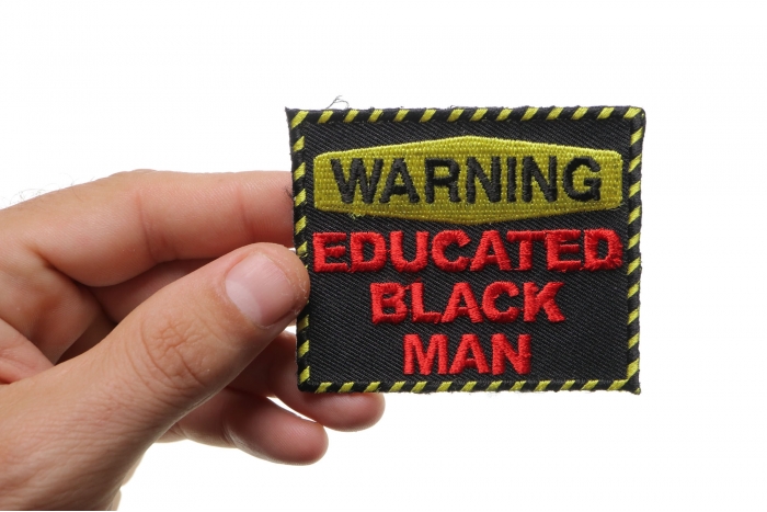 Warning Educated Black Man Funny Iron on Patch shown on hand for size comparison