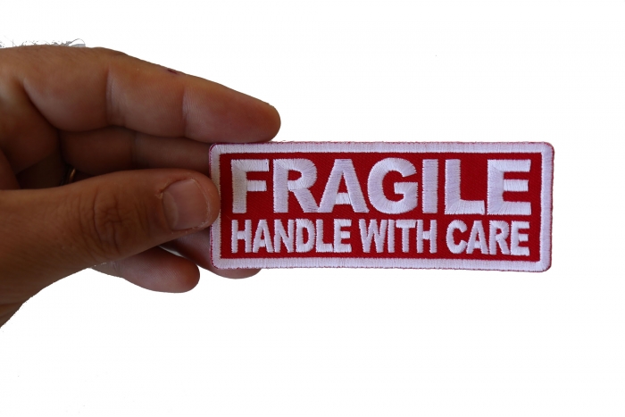Fragile Handle with Care Funny Iron on Patch shown on hand for size comparison