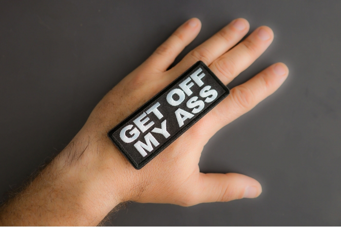 Get Off My Ass Patch shown on hand for size comparison