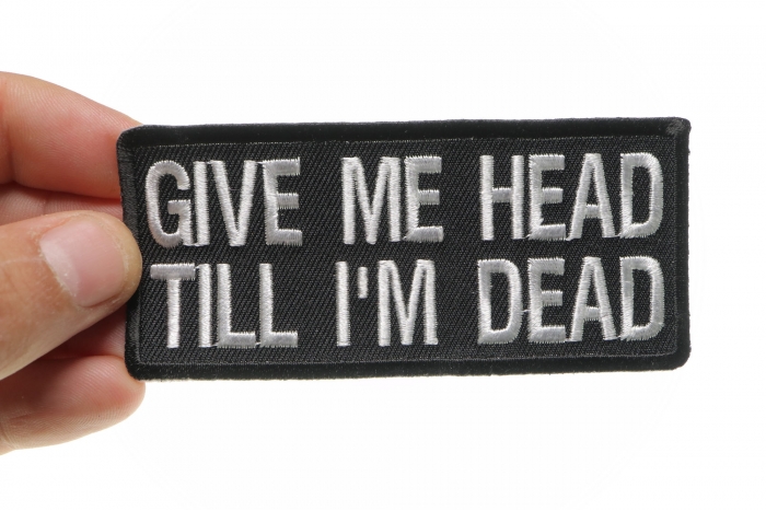 Give Me Head Till I'm Dead Funny Iron on Patch shown on hand for size comparison
