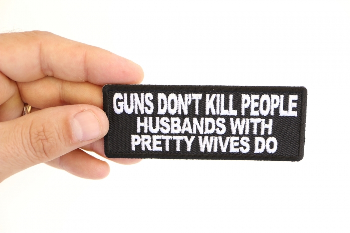 Gun's Don't Kill People Husbands with Pretty Wives Do Funny Iron on Patch shown on hand for size comparison