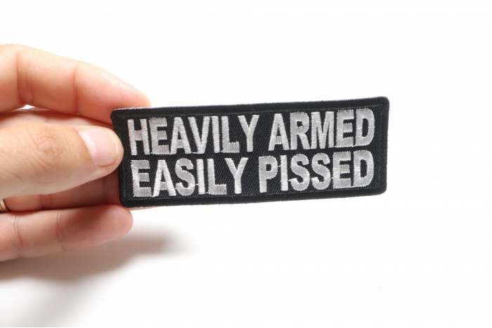 Heavily Armed Easily Pissed Funny Iron on Patch shown on hand for size comparison
