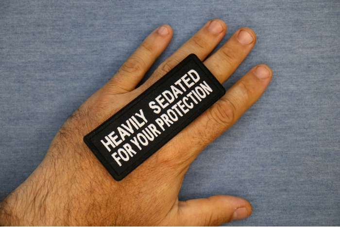 Heavily Sedated For Your Protection Patch, Funny Saying Patches shown on hand for size comparison