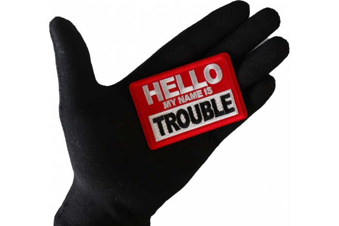 Hello My Name is Trouble Funny Iron on Patch shown on hand for size comparison