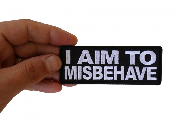 I aim to Misbehave Funny Iron on Patch shown on hand for size comparison