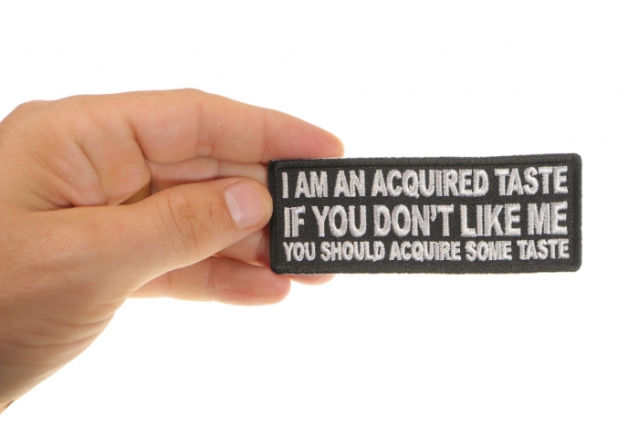 I am an Acquired Taste If You don't Like Me You Should Acquire Some Taste Funny Iron on Patch shown on hand for size comparison