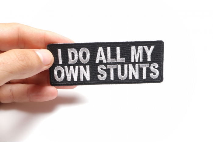 I Do All My Own Stunts Funny Iron on Patch shown on hand for size comparison