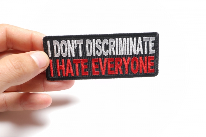 I Don't Discriminate I Hate Everyone Funny Iron on Patch shown on hand for size comparison