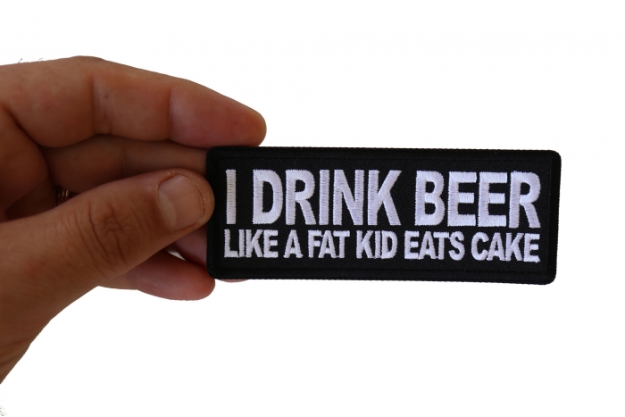 I Drink Beer Like a Fat Kid Eats Cake Funny Iron on Patch shown on hand for size comparison