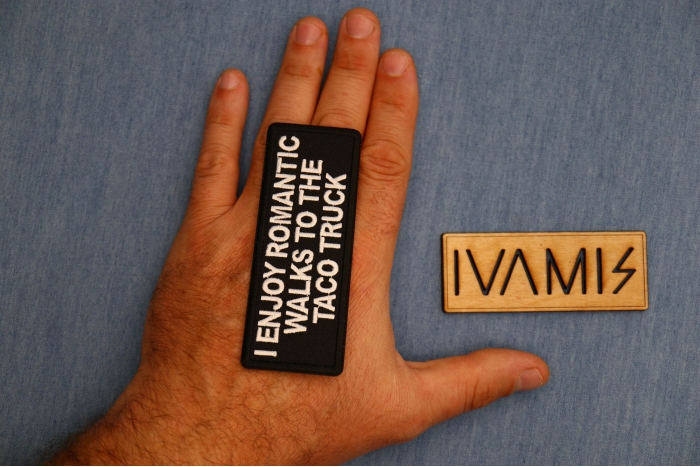 I enjoy Romantic Walks to the Taco Truck Patch, Funny Saying Patches, Sew or Iron on Patch shown on hand for size comparison