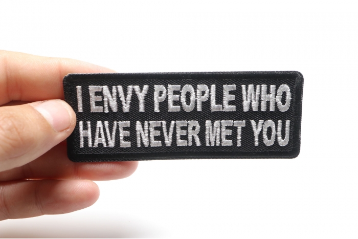 I Envy People Who Have Never Met You Funny Iron on Patch shown on hand for size comparison