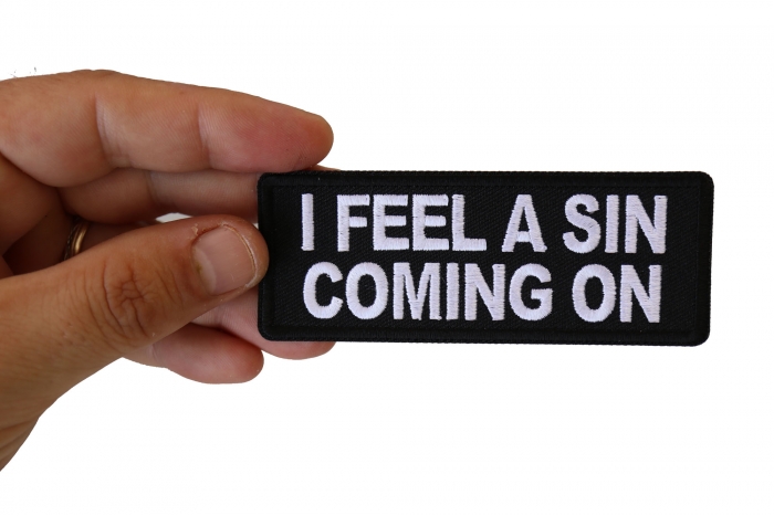 I Feel a Sin Coming On Funny Iron on Patch shown on hand for size comparison