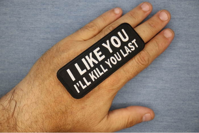 I Like You I Will Kill You Last Funny Iron on Patch shown on hand for size comparison