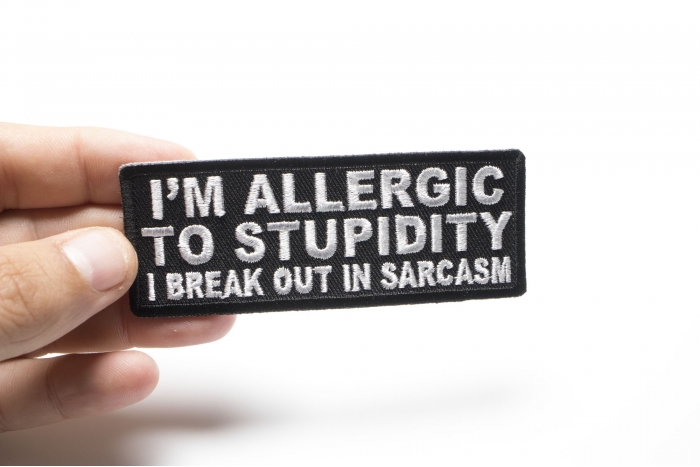 I'm Allergic To Stupidity I Break Out In Sarcasm Funny Iron on Patch shown on hand for size comparison