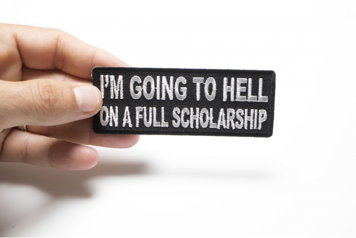 I'm Going To Hell On A Full Scholarship Funny Iron on Patch shown on hand for size comparison