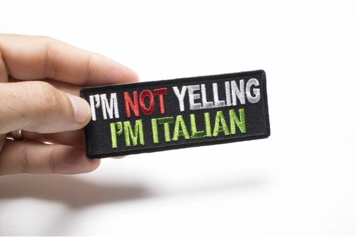 I'm Not Yelling I'm Italian Funny Iron on Patch shown on hand for size comparison