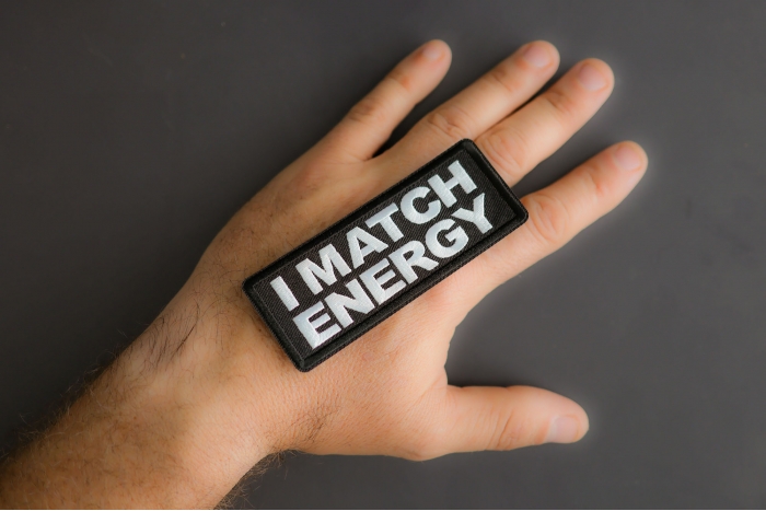I Match Energy Patch shown on hand for size comparison