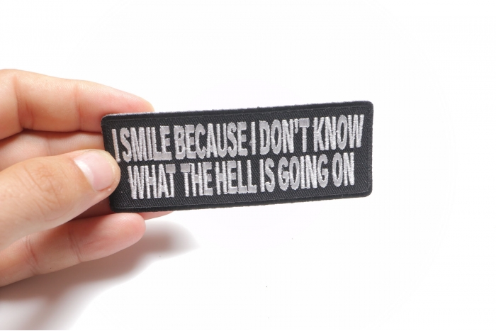 I Smile Because I Don't Know What Is Going On Funny Iron on Patch shown on hand for size comparison