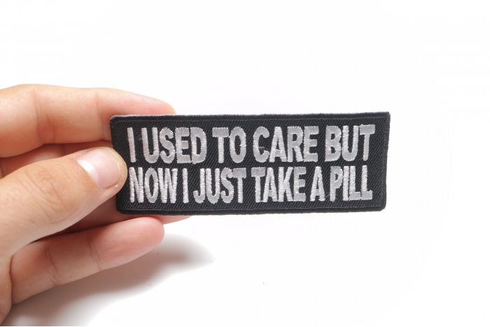 I Used To Care But Now I Take A Pill Funny Iron on Patch shown on hand for size comparison