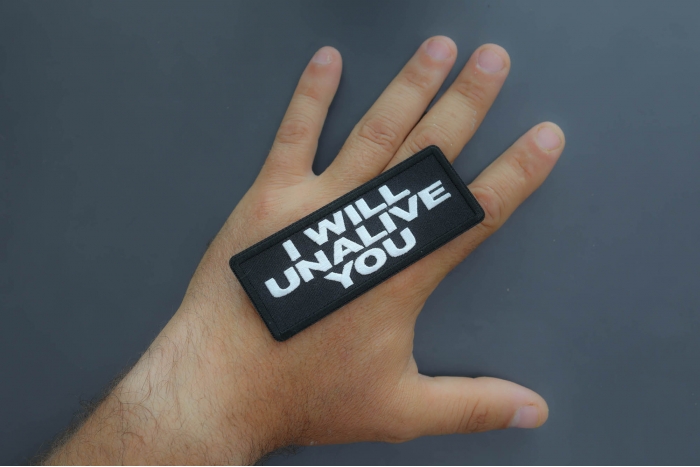 I will unalive you patch shown on hand for size comparison