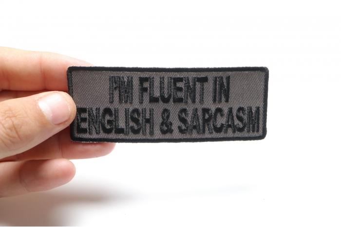 I'm Fluent In English and Sarcasm Funny Iron on Patch shown on hand for size comparison