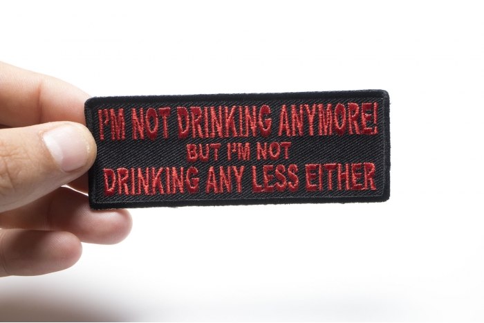 I'm Not Drinking Anymore Not Drinking Any Less Either Funny Iron on Patch In Red shown on hand for size comparison