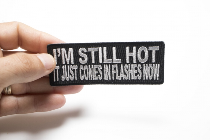 I'm Still Hot It Just Comes In Flashes Funny Iron on Patch shown on hand for size comparison