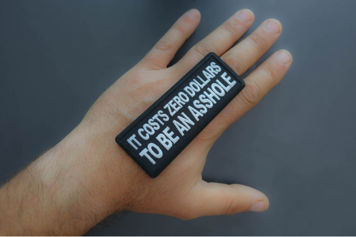 It costs zero dollars to be an asshole Patch shown on hand for size comparison