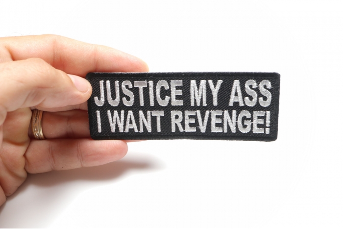 Justice My Ass I Want Revenge Funny Iron on Patch shown on hand for size comparison