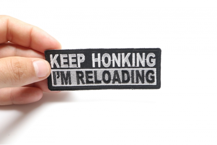 Keep Honking I'm Reloading Patch, Biker Sayings shown on hand for size comparison