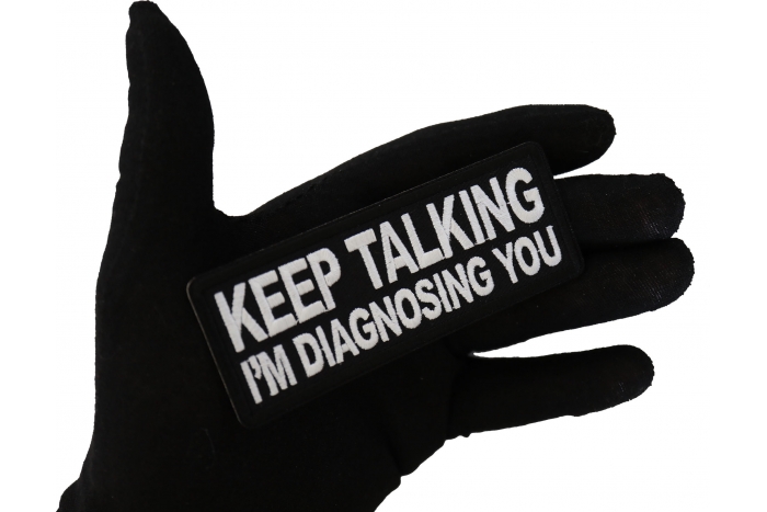 Keep Talking I'm diagnosing you Funny Iron on Patch shown on hand for size comparison