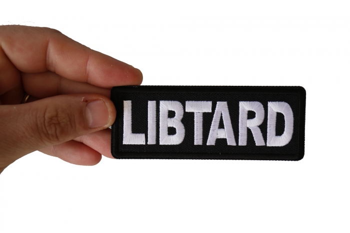 Libtard Funny Iron on Patch shown on hand for size comparison