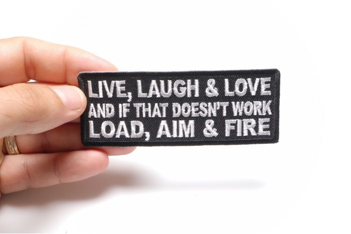 Live Laugh Love and If That Doesn't Work Load Aim and Fire Funny Iron on Patch shown on hand for size comparison