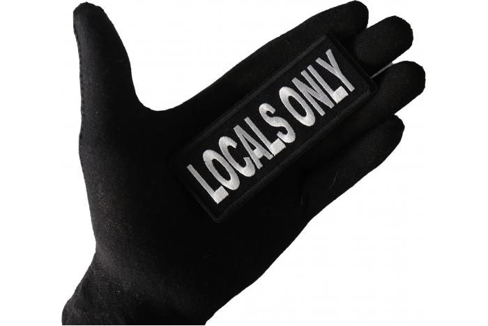 Locals Only Funny Iron on Patch shown on hand for size comparison