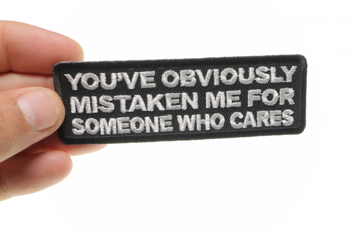 Mistaken Me For Someone Who Cares Funny Iron on Patch shown on hand for size comparison