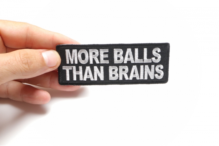 More Balls Than Brains Funny Iron on Patch shown on hand for size comparison