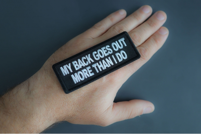 My Back Goes Out More Than I Do Patch shown on hand for size comparison