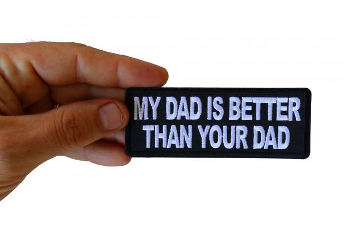 My Dad is Better Than Your Dad Funny Iron on Patch shown on hand for size comparison