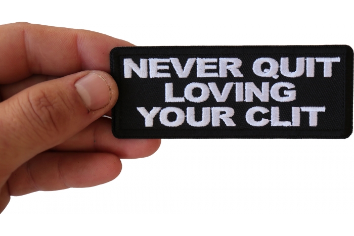 Never Quit Loving Your Clit Funny Iron on Patch shown on hand for size comparison