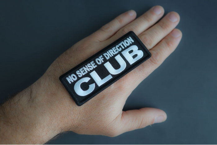 No Sense Of Direction Club Patch shown on hand for size comparison