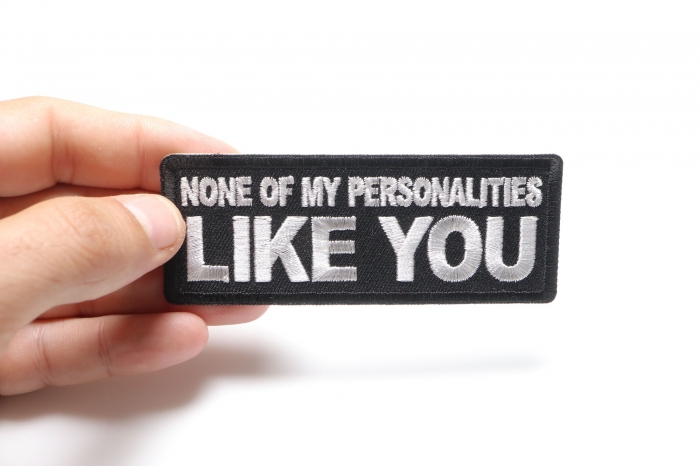 None of My Personalities Like You Funny Iron on Patch shown on hand for size comparison